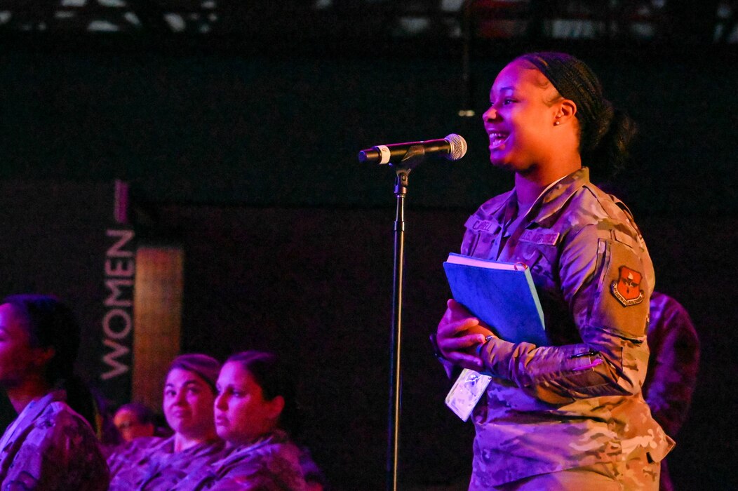 U.S. Air Force Airman First Class Deanna Campbell, 97th Operational Medical Readiness Squadron environmental technician, asks a question during the opening panel at a Torch Athena Rally in San Antonio, Texas Sept. 19, 2023. Campbell asked the panel for advice navigating the Air Force as a young Airman. (U.S. Air Force photo by Airman 1st Class Heidi Bucins)