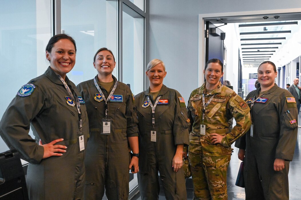Airmen from the 97th Air Mobility Wing pose for a photo at the Torch Athena Rally in San Antonio, Texas, Sept. 19, 2023. The rally was held to discuss critical issues that women in the Air Force face and to build camaraderie amongst each other. (U.S. Air Force photo by Airman 1st Class Heidi Bucins)