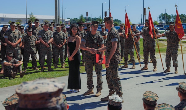 U.S. Marine Corps Lt. Col Jonathan Landers, battalion commander of 2d Battalion, 8th Marine Regiment, 2d Marine Division, commends Navy Petty Officer 3rd Class Clay Campbell, a field medical technician with 2d Battalion, 8th Marine Regiment, 2d Marine Division, for his action on Camp Lejeune, North Carolina, September 15, 2023. Campbell was awarded and recognized for providing medical care to a young woman having a seizure until medics arrived on scene, ultimately saving her life. (U.S. Marine Corps photo by Cpl. Megan Ozaki)