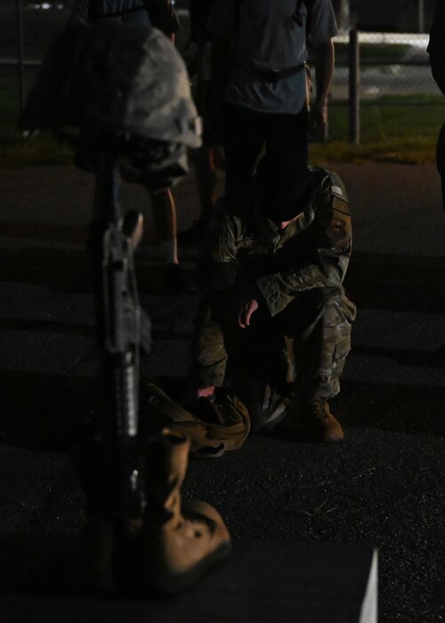 U.S. Air Force Staff Sgt. Evan Adkins, 17th Security Forces Squadron resource protection noncommissioned officer in charge, takes a knee in front of Airman 1st Class Elizabeth Jacobson’s memorial during the Jacobson Memorial Ruck at Goodfellow Air Force Base, Texas, Sept. 28, 2023. Jacobson was 21 years old when her convoy was struck with an improvised explosive device, in which she paid the ultimate price while protecting her country. Members rucked from the 17th SFS’s building to the Jacobson Gate and passed Jacobson’s memorial on the way to the finish line. (U.S. Air Force photo by Senior Airman Sarah Williams)