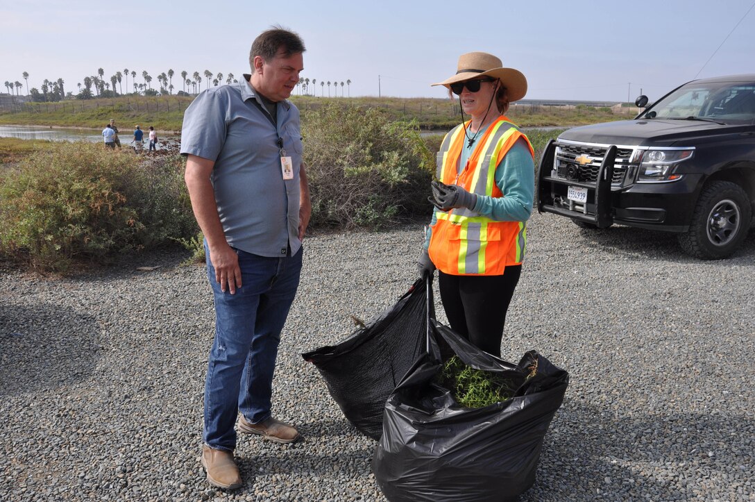 Brian Paul, Natural Resource program manager with the LA District’s Operations Division discuss Dittrichia graveolens, or stinkwort, with LA District biologist Tiffany Armenta during a volunteer cleanup of the Santa Ana River Marsh, Sept. 23, in Newport Beach, Calif.