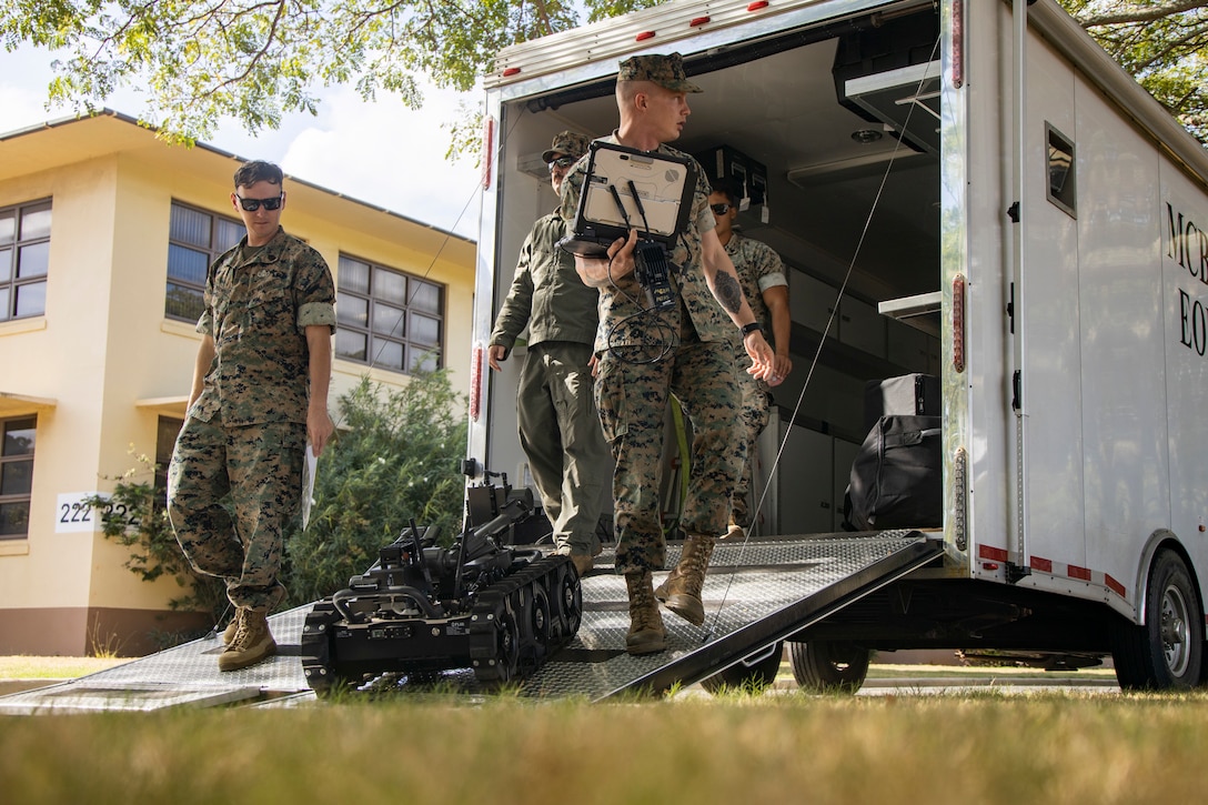 U.S. Marine Corps explosive ordnance disposal (EOD) technicians with Marine Corps Base Hawaii EOD, unloads a Man Transportable Robotic System Increment II (MTRS Inc II) during a capabilities and educational demonstration for Military Homeschoolers of Hawaii students at MCBH, Sept. 21, 2023. Participants learned about military occupations, specifically those related to Science, Technology, Electronics, and Math, from MCBH EOD and Marathon Targets, a military technology company. (U.S. Marine Corps photo by Sgt. Julian Elliott-Drouin)