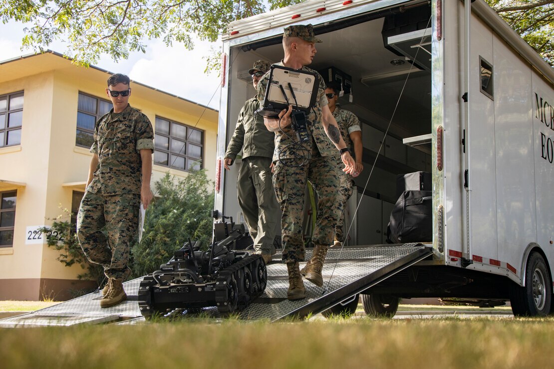 U.S. Marine Corps explosive ordnance disposal (EOD) technicians with Marine Corps Base Hawaii EOD, unloads a Man Transportable Robotic System Increment II (MTRS Inc II) during a capabilities and educational demonstration for Military Homeschoolers of Hawaii students at MCBH, Sept. 21, 2023. Participants learned about military occupations, specifically those related to Science, Technology, Electronics, and Math, from MCBH EOD and Marathon Targets, a military technology company. (U.S. Marine Corps photo by Sgt. Julian Elliott-Drouin)