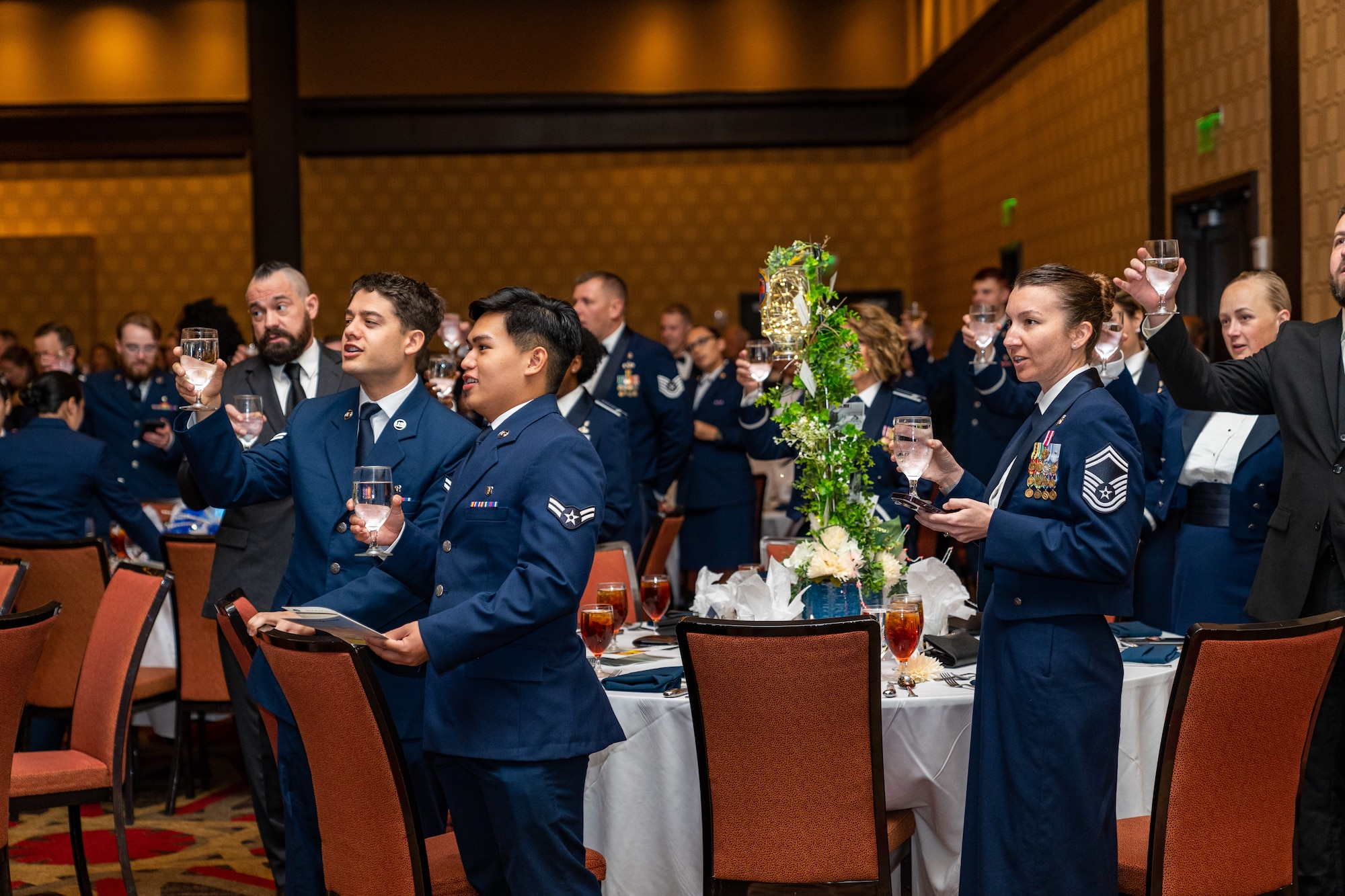 U.S. Air Force Airmen from Keesler Air Force Base raise their glasses for a toast during the 2023 Air Force Ball at the Golden Nugget Casino, Mississippi, Sept. 23, 2023.
