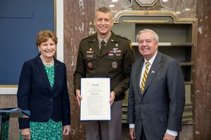 Sen. Jeanne Shaheen and Lindsey Graham, Senate National Guard Caucus co-chairs, present Army Gen. Daniel Hokanson, chief, National Guard Bureau, with a formal copy of Senate Resolution 308 to recognize the historic significance of the 30th anniversary of the founding of the Department of Defense National Guard Bureau State Partnership Program, Dirksen Senate Office Building, Washington, D.C., Sept. 27, 2023. The State Partnership Program was established in 1993 to assist countries emerging from behind the Iron Curtain. It now includes 88 partnerships with 100 nations and the National Guard of every state, territory and the District of Columbia.