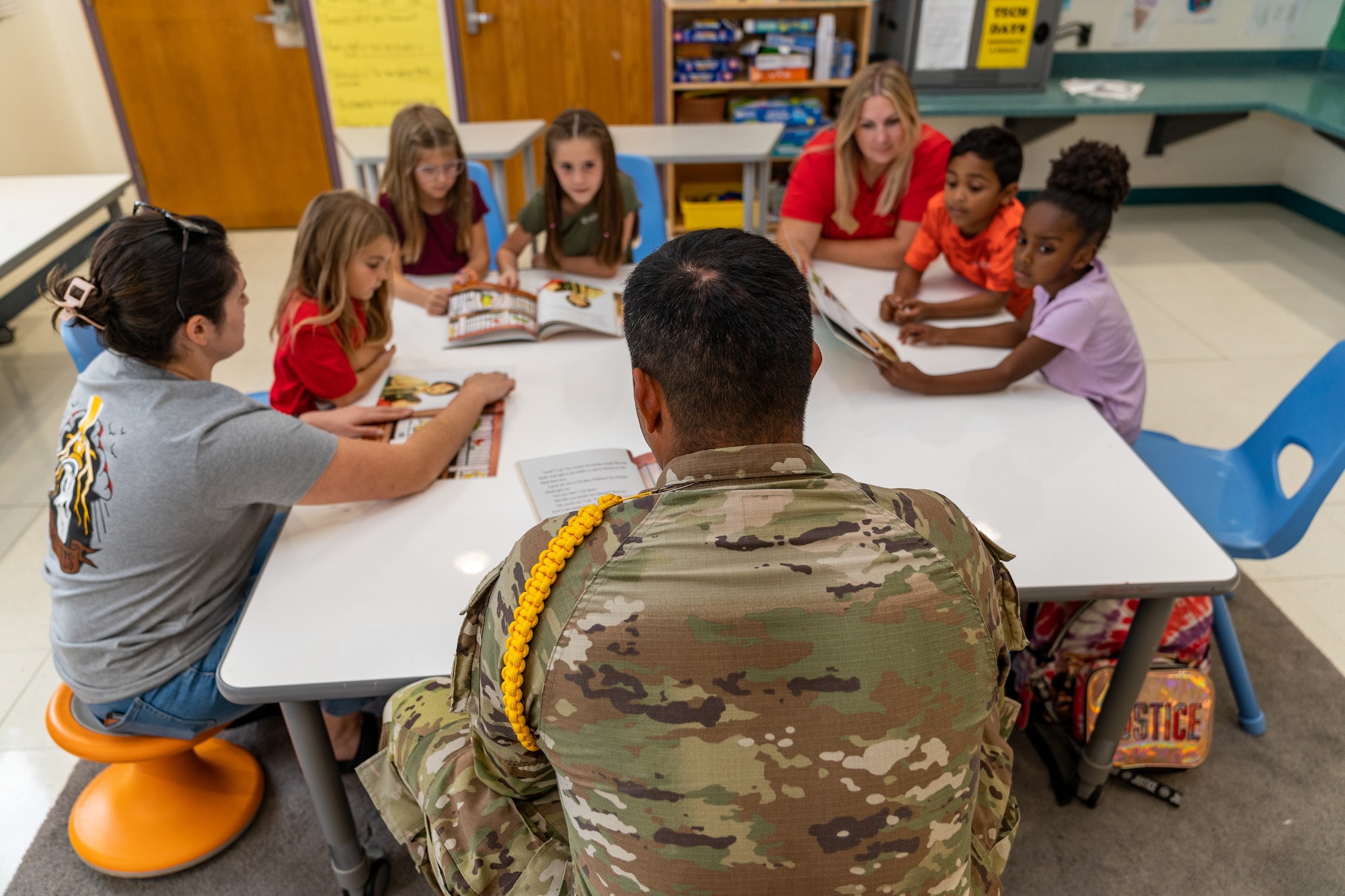 U.S. Air Force Airman 1st Class Martin Payan, 336th Training Squadron student, reads “Mango, Abuela, and Me” by Meg Medina to a group of students for Hispanic Heritage Month at Keesler Air Force Base, Mississippi, Sept. 27, 2023.