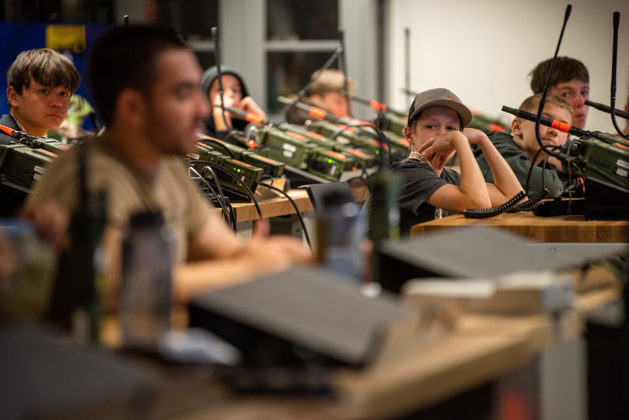 Boy Scouts watch as TACP students practice communication skills in their radio lab classroom.