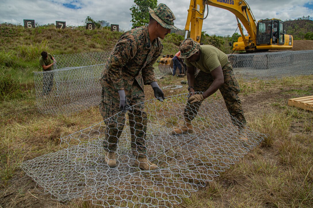 U.S. Marine Corps Sgt. Israel Garcia, left, a native of Houston, and Lance Cpl. Jeremy Ferdinand, a native of Chaguanas, Trinidad and Tobago, both combat engineers with Task Force Koa Moana 23, assemble a stack of chicken wire into cubes during a range renovation project on Goldie River Training Camp, Port Moresby, Papua New Guinea, Sept. 12, 2023. Task Force Koa Moana 23, composed of U.S. Marines and Sailors from I Marine Expeditionary Force, deployed to the Indo-Pacific to strengthen relationships with Pacific Island partners through bilateral and multilateral security cooperation and community engagements. (U.S. Marine Corps photo by Lance Cpl. Ricardo Ramirez)