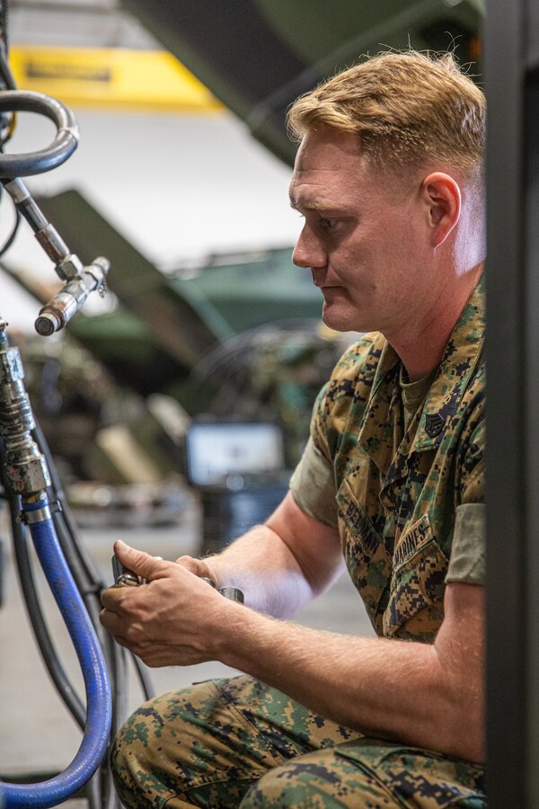 U.S. Marine Corps Staff Sgt. Thomas Bedman, the assistant maintenance chief with Bravo Company, 3rd Assault Amphibian Battalion, 1st Marine Division, completes routine maintenance on an Amphibious Combat Vehicle at Marine Corps Base Camp Pendleton, California, Sept. 15, 2023. Bedman began his Marine Corps career as a main battle tank technician prior to becoming an ACV technician. Bedman is a native of Carlos, Minnesota. (U.S. Marine Corps photo by Lance Cpl. Logan Courtright)