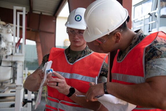 Joint Task Force-Red Hill (JTF-RH) communications directorate team members, U.S. Marine Corps Cpl. Connor Jones, left, and U.S. Marine Corps Staff Sgt. Jimmy Luna, conduct tamper seal checks as a safety measure in preparation for defueling operations on Joint Base Pearl Harbor-Hickam, Hawaii, Sept. 26, 2023. JTF-RH is in phase four of its five-phase defueling plan where personnel are focused on completion of pre-defueling material assessments, continued training and rehearsals, routine maintenance actions, and quality assurance and safety checks. This is the final preparatory stage prior to commencement of gravity defueling on Oct. 16 and marks the final coordination with the Department of Defense, Environmental Protection Agency, and Hawaii Department of Health before approval to defuel is received. (DoD photo by U.S. Navy Mass Communication Specialist 1st Class Jordan KirkJohnson)