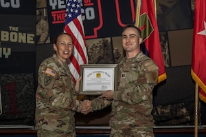 U.S. Army Brig. Gen. Niave F. Knell, the 1st Infantry Division deputy commanding general of support, awards a Certificate of Appreciation to Cpt. Alex Armitage, a Soldier assigned to 1st Heavy Attack Reconnaissance Squadron, 6th Cavalry Regiment, 1st Combat Aviation Brigade, 1st Inf. Div., at Victory Hall on Fort Riley, Kansas, Sep. 6, 2023. Armitage helped raise money for the program that will then be used to help other Soldiers in need. (U.S. Army photo by Spc. Mackenzie Striker)