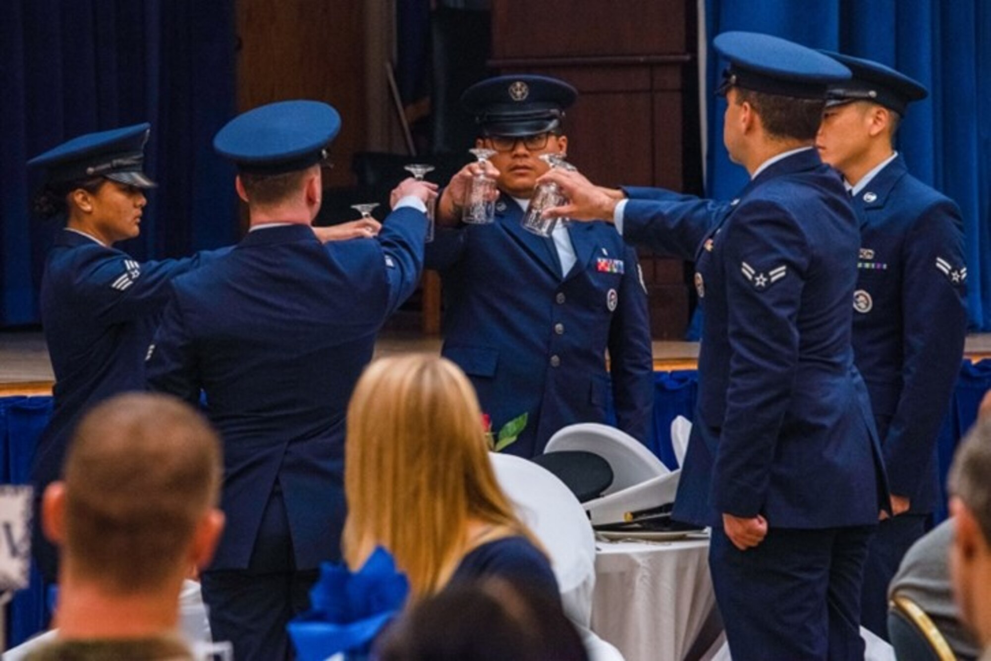 U.S. Air Force Airmen from the 51st Fighter Wing base honor guard invert empty glasses during a prisoner of war and missing in action ceremony at Osan Air Base, Republic of Korea, Sept. 27, 2023. The POW/MIA table is a solemn reminder to honor service members who have become prisoners of war or have gone missing in action. (U.S. Air Force photo by Airman 1st Class Chase Verzaal)