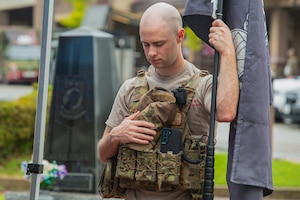 U.S. Air Force Senior Airman Alec Moore, 51st Civil Engineer Squadron explosive ordnance disposal technician, bows his head for an invocation during a prisoner of war and missing in action remembrance ceremony at Osan Air Base, Republic of Korea, Sept. 26, 2023. Osan hosted a 24-hour POW/MIA run to honor those who were captured or went missing in combat, allowing friends, families and service members to remember their sacrifice. (U.S. Air Force photo by Airman 1st Class Chase Verzaal)