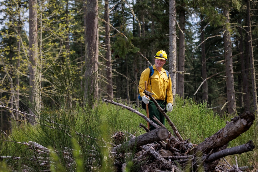 A guardsman walks through a wooded area.