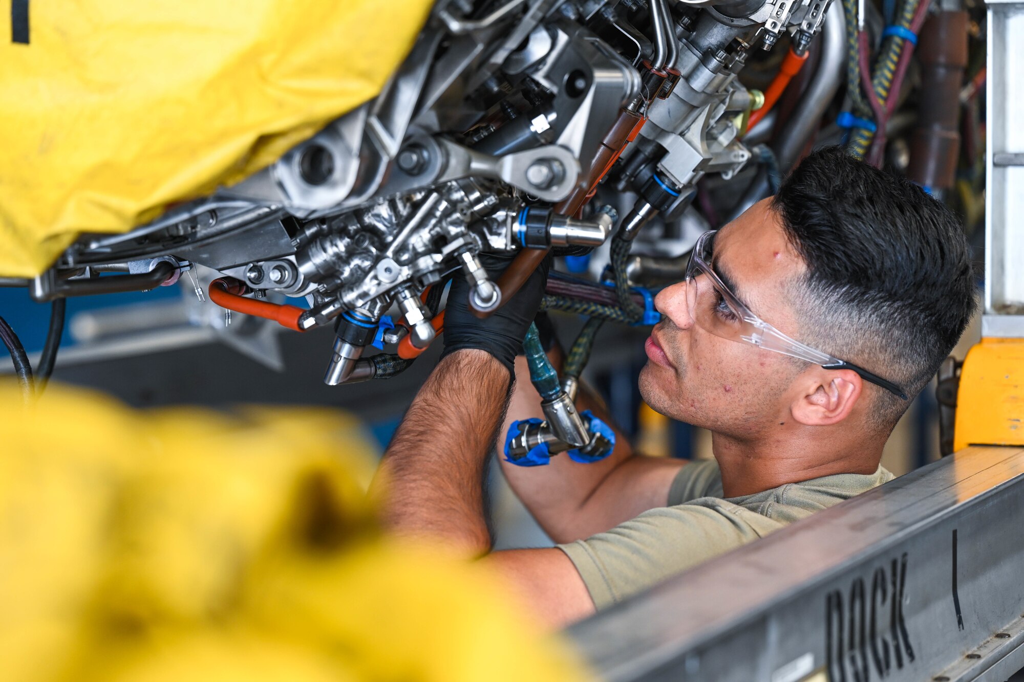 Airman 1st Class Mota Miquesias, 15th Maintenance Squadron aerospace propulsion journeyman, works on an engine of an F-22 Raptor at Joint Base Pearl Harbor-Hickam, Hawaii, Aug. 2, 2023. Miquesias performed routine maintenance on the engine and checked it for any discrepancies during a quality-control check. (U.S. Air Force photo by Senior Airman Makensie Cooper)