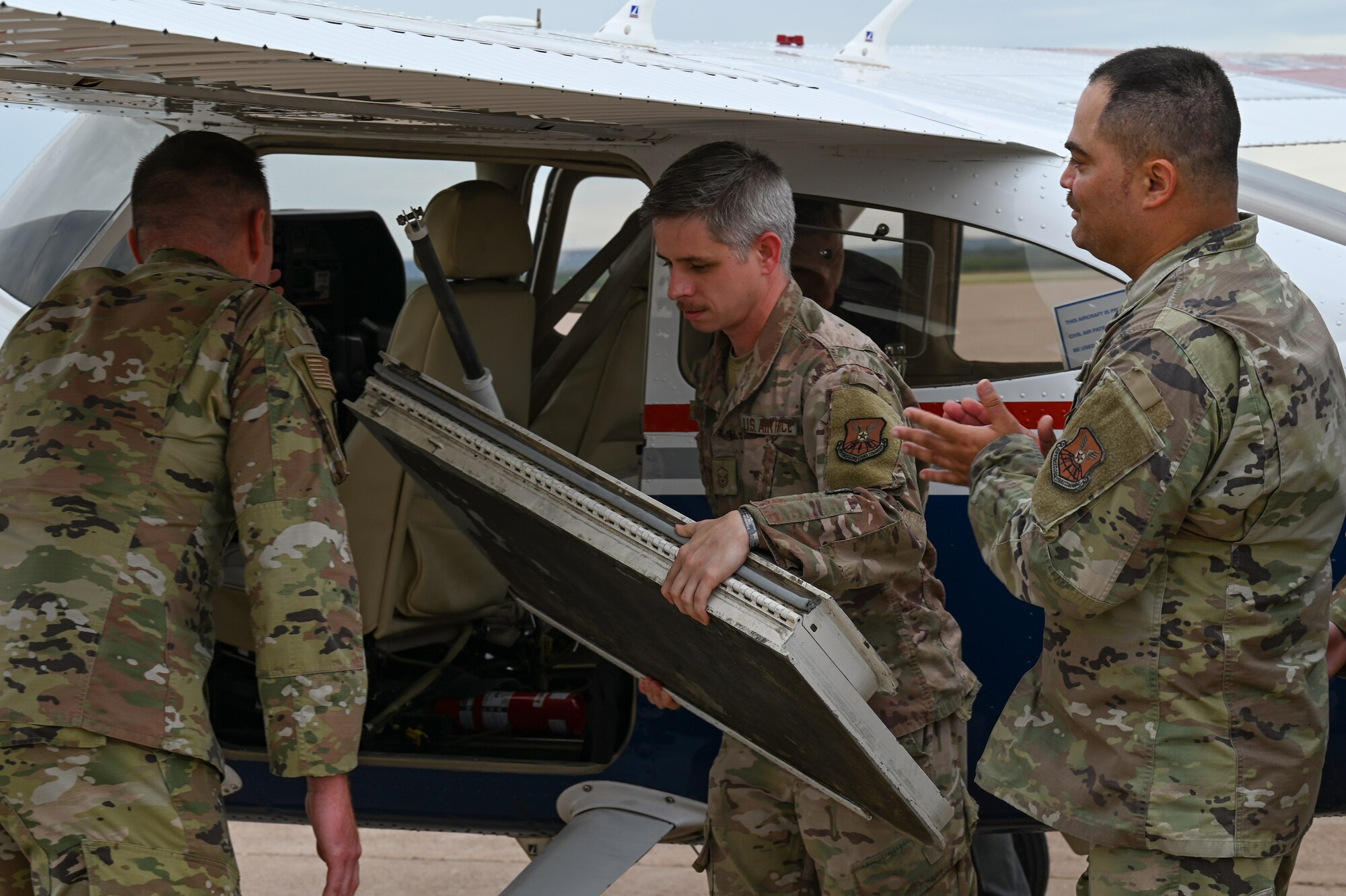 Master Sgt. Samuel Bramley, 7th Logistics Readiness Squadron maintenance support liaison section chief, removes the crew entry door from the Cessna 182 Skylane at Dyess Air Force Base, Texas, Sept. 21, 2023. This mission demonstrates the significant contributions of civilian organizations like the Civil Air Patrol in strengthening our nation's defense infrastructure. (U.S. Air Force photo by Senior Airman Sophia Robello)
