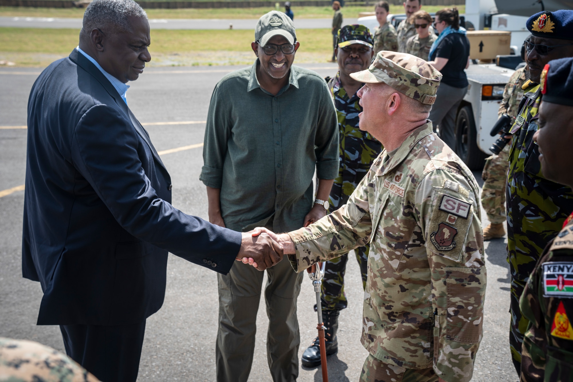 U.S. Secretary of Defense Lloyd J. Austin III and Kenyan Cabinet Secretary of the Ministry of Defence Aden Duale are greeted by U.S. Air Force Lt. Col. John Farmer, 475th Expeditionary Air Base Squadron commander