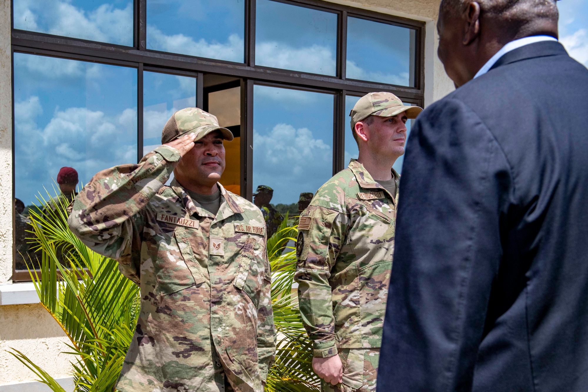 U.S. Air Force Staff Sgt. Cecilio Fantauzzi, pavements and construction noncommissioned officer in charge assigned to the 475th Expeditionary Air Base Squadron salutes U.S. Secretary of Defense Lloyd J. Austin III