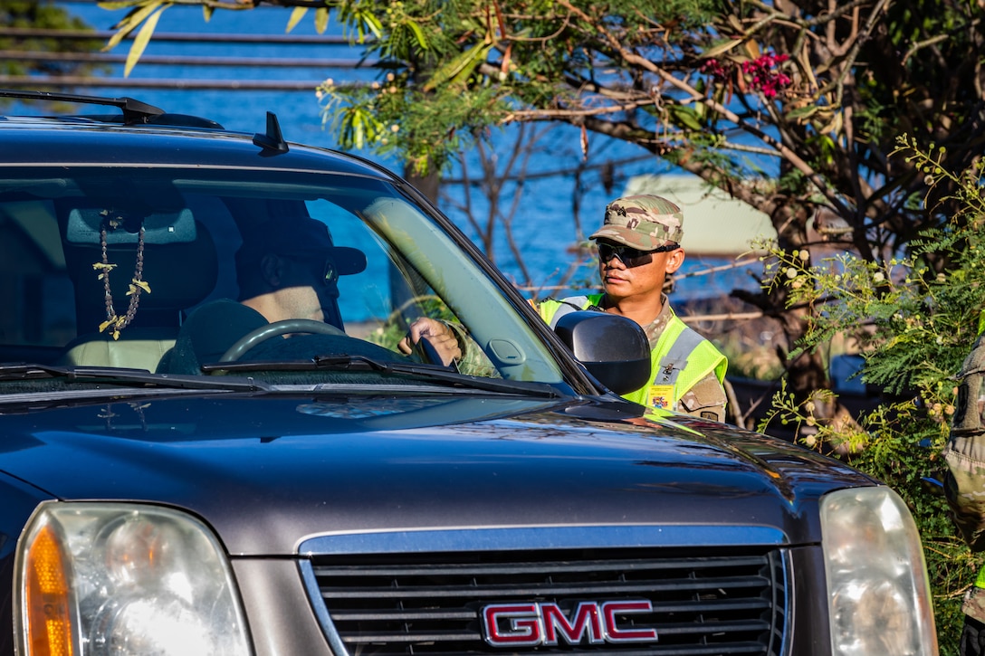 A soldier assists community members authorized to return to their residences.