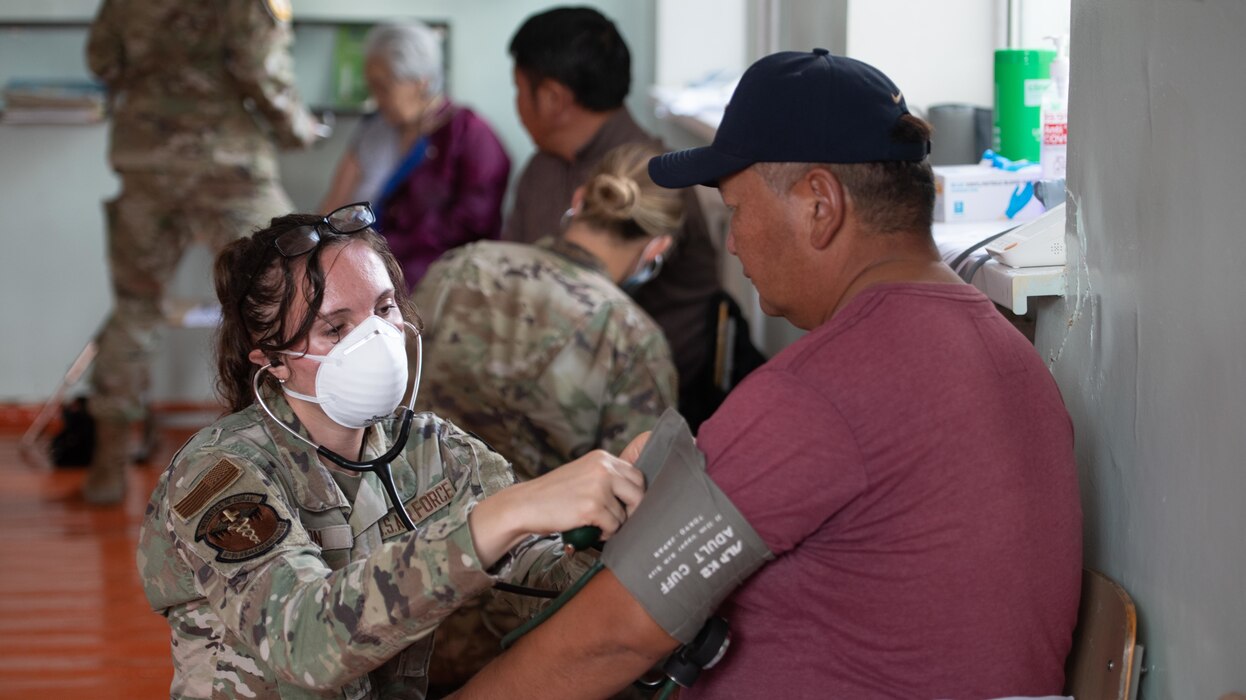 Image of an Airman treating a patient.