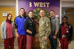 Lt. Col. Benjamin Smith, center right, a pediatric oncologist at Walter Reed National Military Medical Center, poses for a group photo with other Walter Reed pediatric staff in the Pediatric Clinic at Walter Reed in Bethesda, Maryland, Sept. 25, 2023. Smith specializes in blood diseases, bleeding disorders, and cancers.