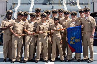 The newest members of the chief's mess pose for a photo aboard  USS Ralph Johnson (DDG 114) after a chief pinning ceremony in the Philippine Sea.