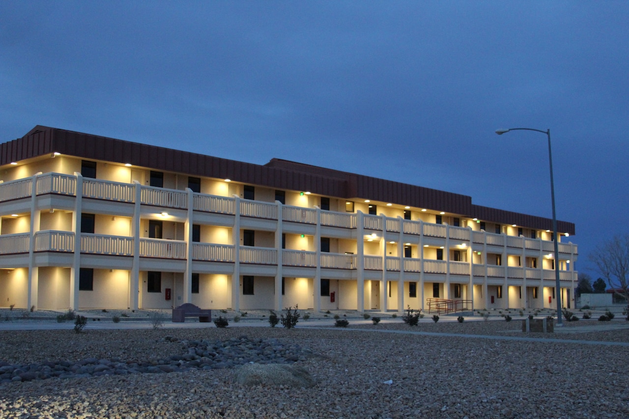 An evening view of military barracks shows its resemblance to civilian apartments.
