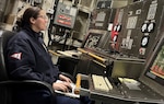 Petty Officer 1st Class Britney Cabrales monitors the engineering plant in Main Control aboard the Coast Guard Cutter William Tate during a family cruise. (U.S. Coast Guard photo by Anthony Cabrales)