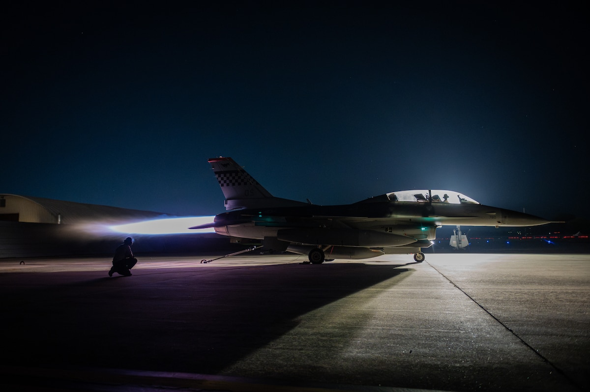 U.S. Air Force crew chiefs from the 36th Fighter Generation Squadron run a maximum power check on an F-16 Fighting Falcon