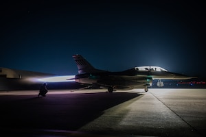 U.S. Air Force crew chiefs from the 36th Fighter Generation Squadron run a maximum power check on an F-16 Fighting Falcon