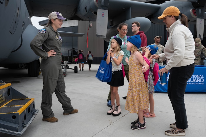 1st Lt. Riley Komurka, 93th Airlift Squadron pilot, speaks with visiting families at the Girls in Aviation event at Flying Cloud Airport in Eden Prairie, Minnesota, Sept. 23, 2023. Komurka had recently returned from a deployment in Djibouti, where she helped provide C-130H Hercules tactical airlift support to multiple users in East Africa. (U.S. Air Force photo by Senior Airman Victoriya Tarakanova)
