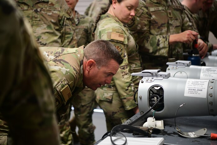 U.S. Air Force Master Sgt. Paul Smith, 9th Munitions Squadron Air Force Combat Ammunition Center combat advisor, checks for discrepancies during the hands-on training portion of the senior officer orientation (SOO) course on Beale Air Force Base, California on Sept. 25, 2023.