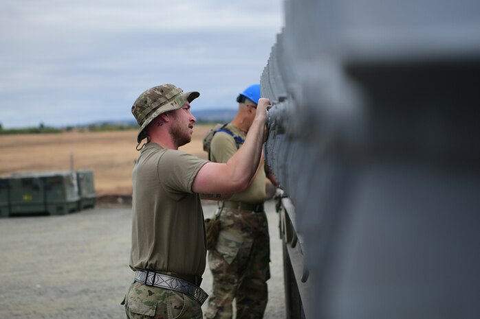 A 9th Munitions Squadron Airman inspects munitions loaded on a truck bed on Beale Air Force Base, California on Sept. 25, 2023.