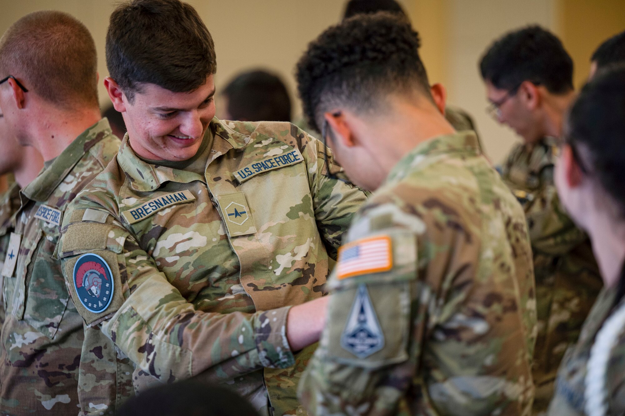 U.S. Space Force Guardians assigned to the 533rd Training Squadron Detachment 2, put on their unit patches during the 533rd TRS Det 2 activation and Assumption of Command ceremony at Keesler Air Force Base, Mississippi, Sept. 19, 2023.