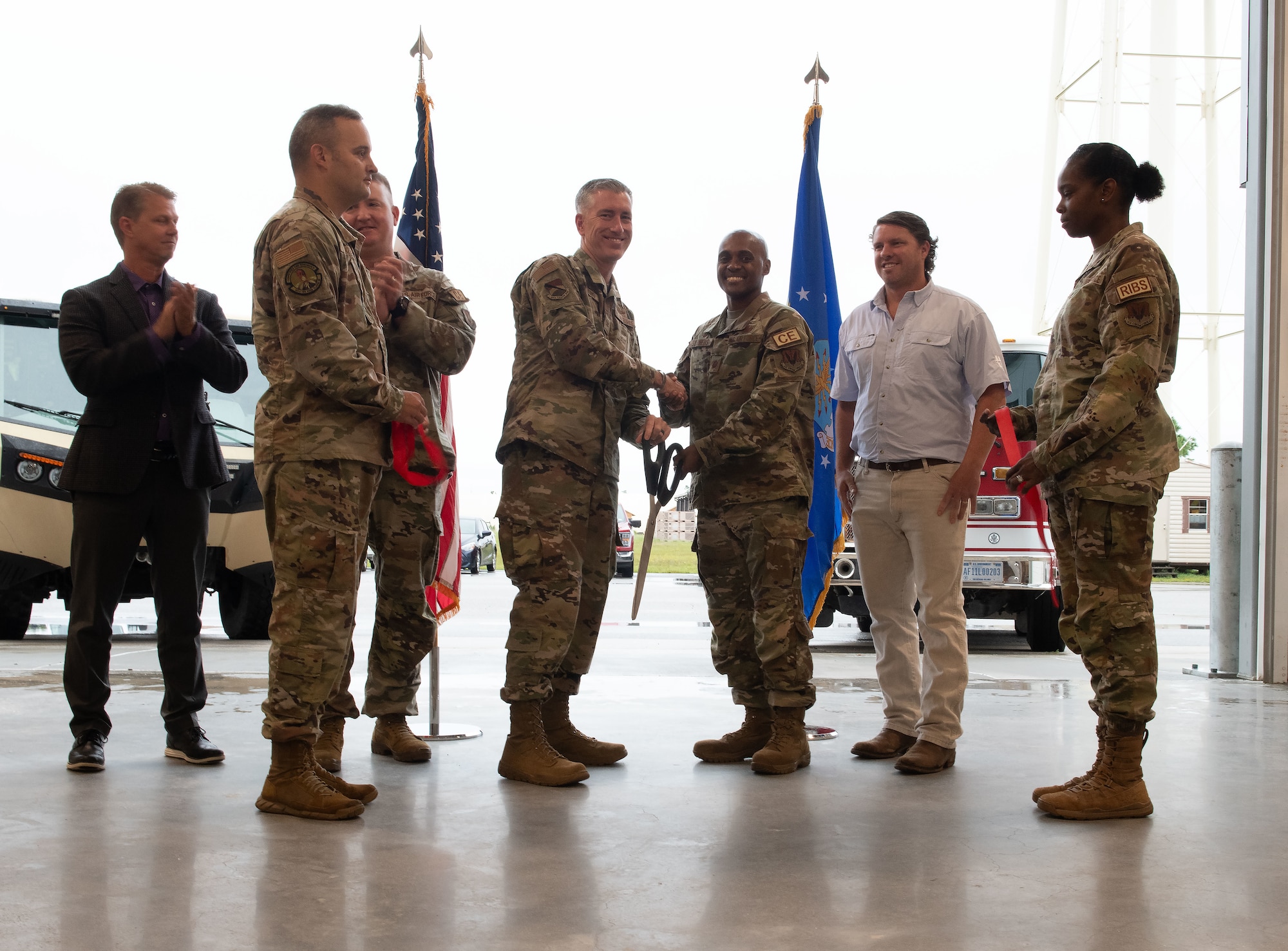 A group of military personnel cutting a ribbon on a new facility.