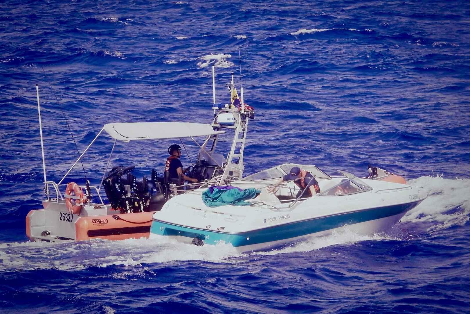 USCGC Myrtle Hazard (WPC 1139) tows a disabled vessel en route to Rota after the 11 aboard were airlifted on July 10, 2023. The crew secured evidence and transferred the boat to the CNMI Department of Public Safety and Homelands Security Investigations at the pier in Rota for further investigation. (U.S. Coast Guard photo)