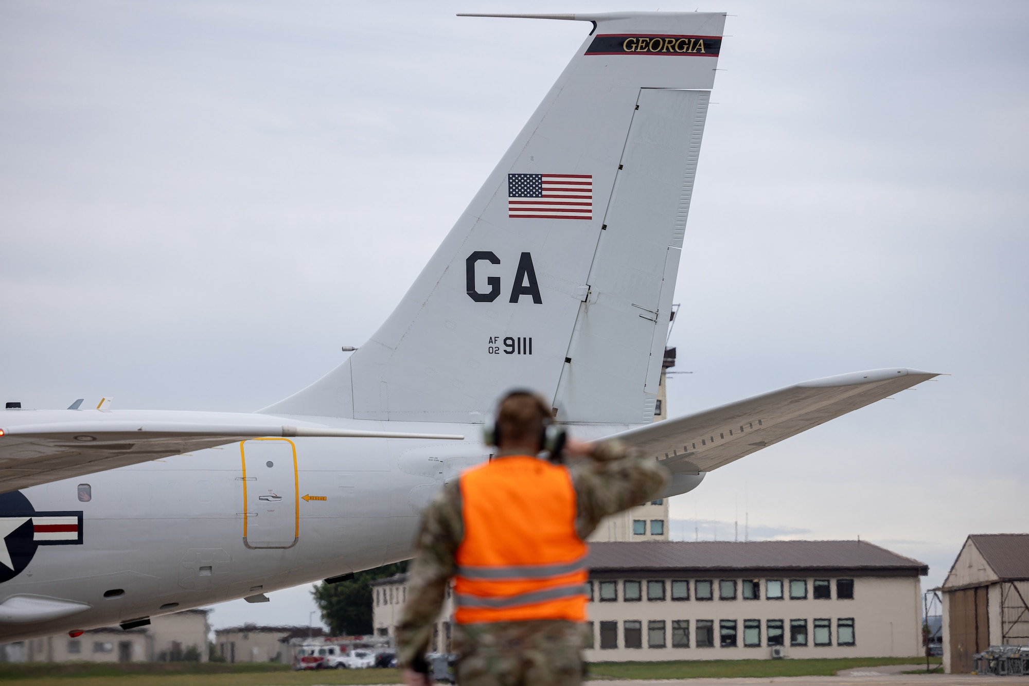 U.S. Airman with the 116th Air Control Wing, Georgia Air National Guard, marshals an E-8C Joint STARS during its last mission at Ramstein Air Force Base,  Germany, Sept. 18, 2023.