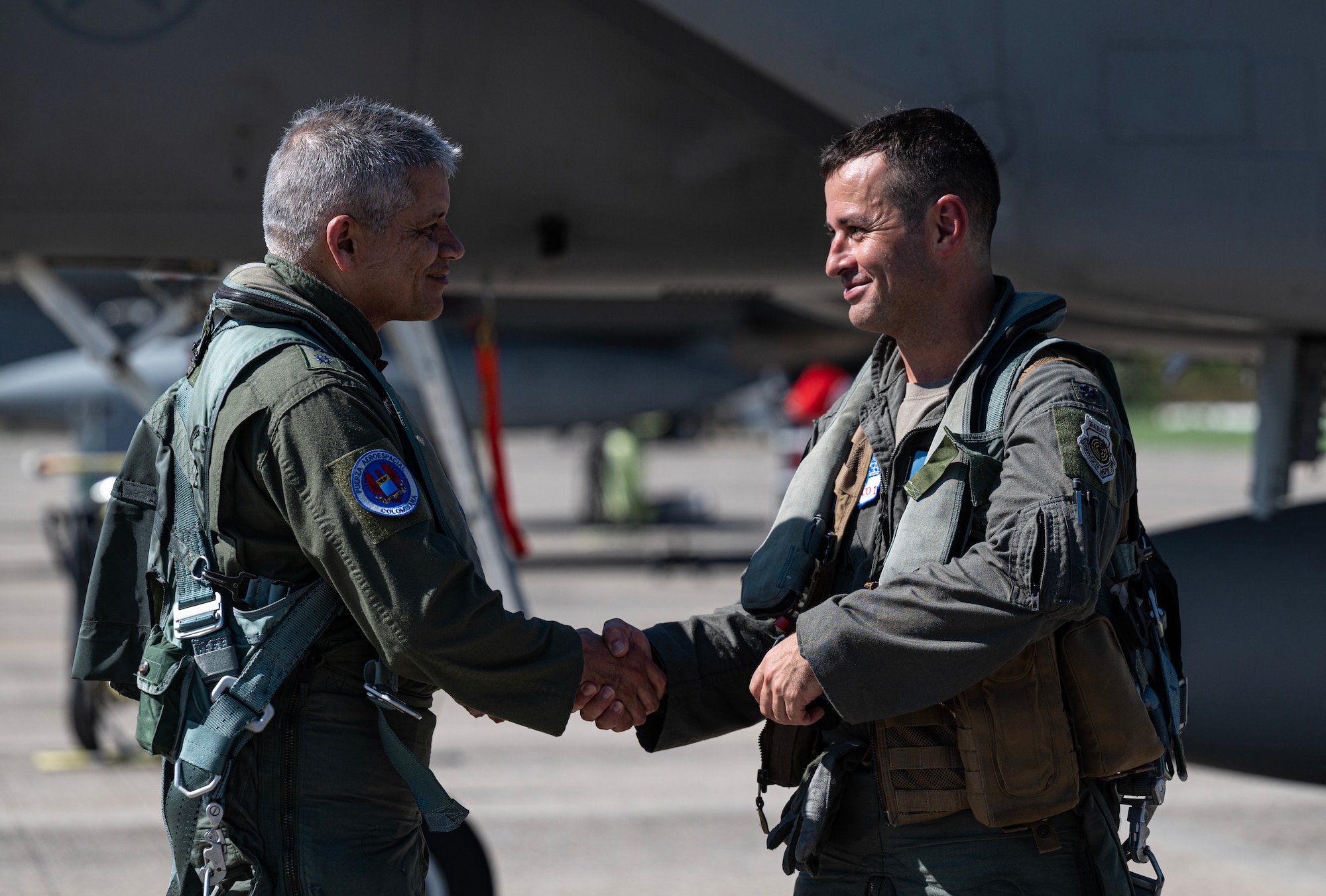 Colombia Aerospace Force (COLAF) Maj. Gen. Carlos Fernando Silva Rueda (left), Second Commander and Chief of Staff of the COLAF, shakes hands with U.S. Air Force Lt. Col. Daniel Schiller (right), 125th Fighter Wing chief of safety, Florida Air National Guard, after a training sortie during exercise Rel‡mpago VIII in Palanquero, Colombia, Aug. 30, 2023. COLAF and U.S. Air Force aircraft fly together and against one another in training using NATO standards to promote seamless interoperability. (U.S. Air Force photo by Senior Airman Bryan Guthrie)