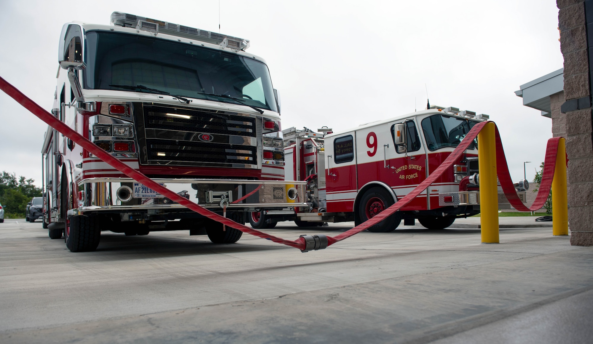 Two rescue vehicles parked outside a fire station.