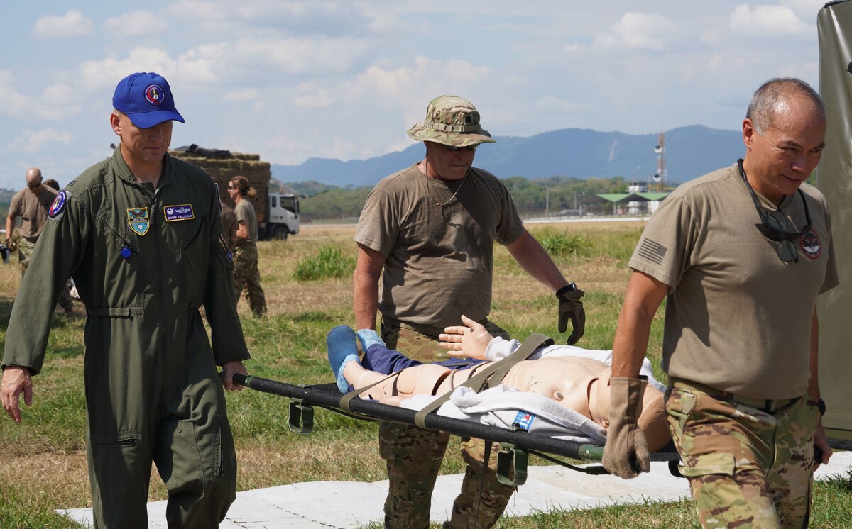 U.S. Air Force Col. Mathew Volkommer, 612th Air Operations Center commander, helps carry a stretcher with air medical evacuation team members during exercise Angel de los Andes  Aug. 14, 2023 in Palanquero, Colombia. The ADLA/Relampago combined exercise honors our promise to be a trusted partner in the region by increasing collaboration, enhancing interoperability, and building partner nation capacity so that we can quickly work together when support is needed.(U.S. Air Force photo by Airman 1st Class Juliana Londono)
