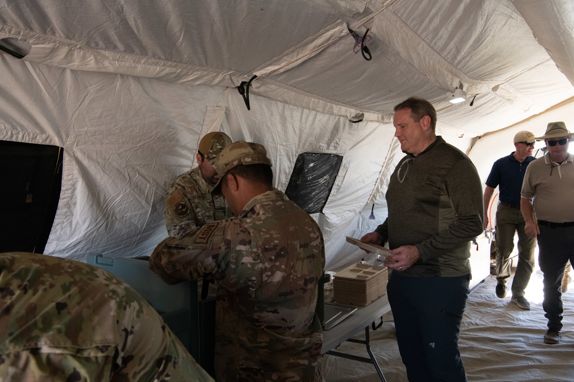 Members of the 27th Special Operations Wing’s Mission Sustainment Team prepare lunch in a field kitchen for Secretary Andrew Hunter, Assistant Secretary of the Air Force for Acquisition, Technology and Logistics, at Melrose Air Force Range, Melrose, N.M.