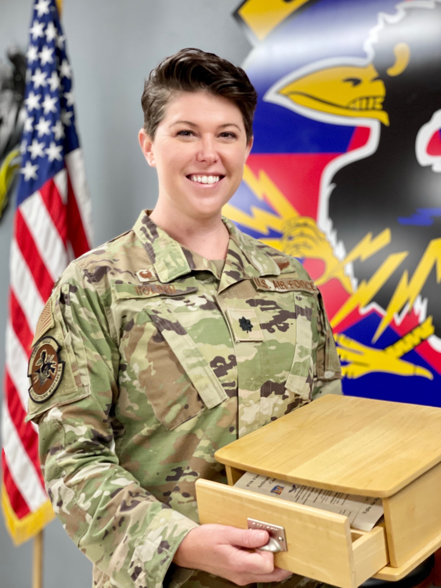 U.S. Air Force Lt. Col. Kera A. Rolsen, 950th Spectrum Warfare Group activation project officer, lays in a hospital bed. (Courtesy Photo)