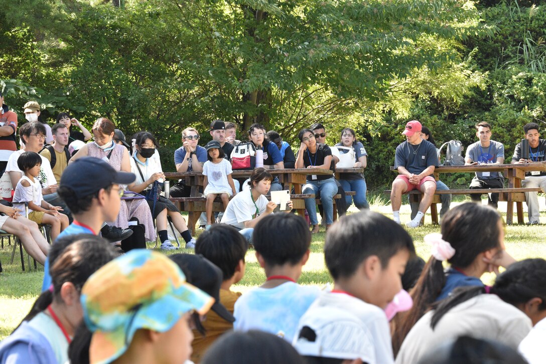 Audience members listen to children recount their English Camp Memories, September 18, 2023. CATC Camp Fuji Marines mentored Japanese children through English Camp emersion course hosted by the National Chuo Youth Friendship Center in Gotemba, Japan.  (U.S. Marine Corps photo by Song Jordan)