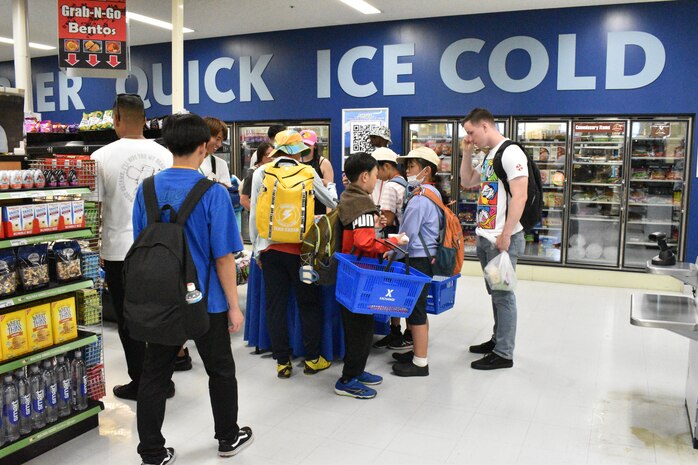 Corporal Kenneth Monaghan stands by to assist children as they shop at the Camp Fuji Exchange.