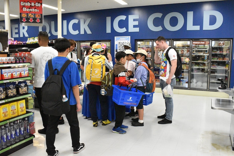 Corporal Kenneth Monaghan stands by to assist children as they shop at the Camp Fuji Exchange.