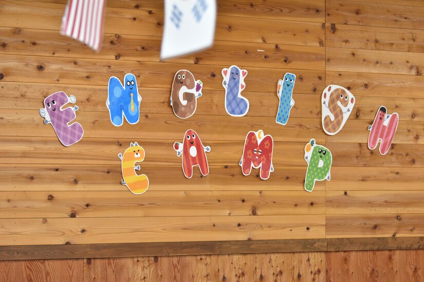 A sign on display during English Camp weekend, reads “English Camp,” in colorful letters.