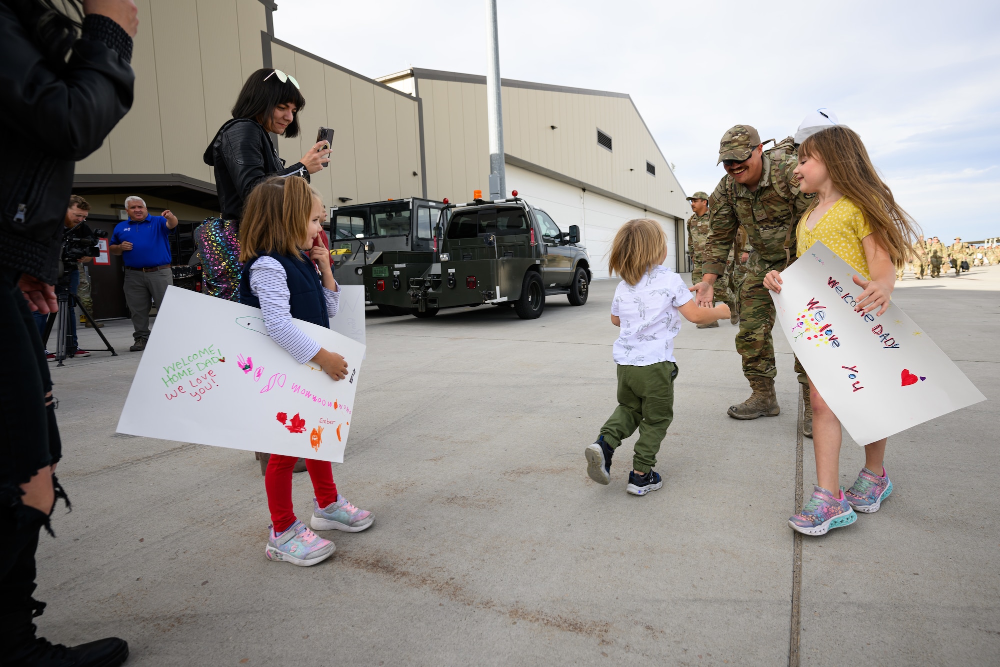 A photo of Airmen and family embracing