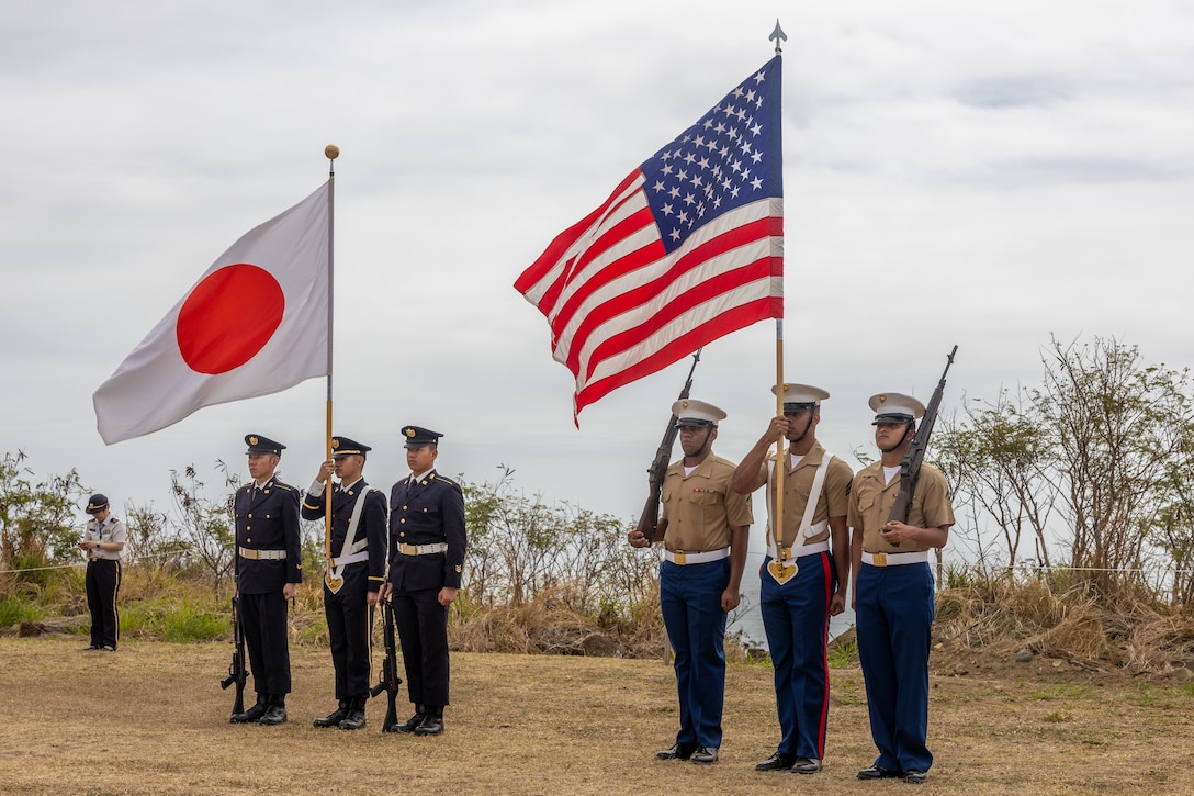 U.S. Marines with the III Marine Expeditionary Force color guard and the Japan Ground Self-Defense Force color guard prepare to march during the Reunion of Honor ceremony on Iwo To, Japan, March 30, 2024. The 79th annual Reunion of Honor ceremony commemorates the veterans who fought for their respective countries on this hallowed ground; their battle has inspired future generations to value and maintain peace, security and stability in the Indo-Pacific region and beyond. (U.S. Marine Corps photo by Sgt. Christian M. Garcia)
