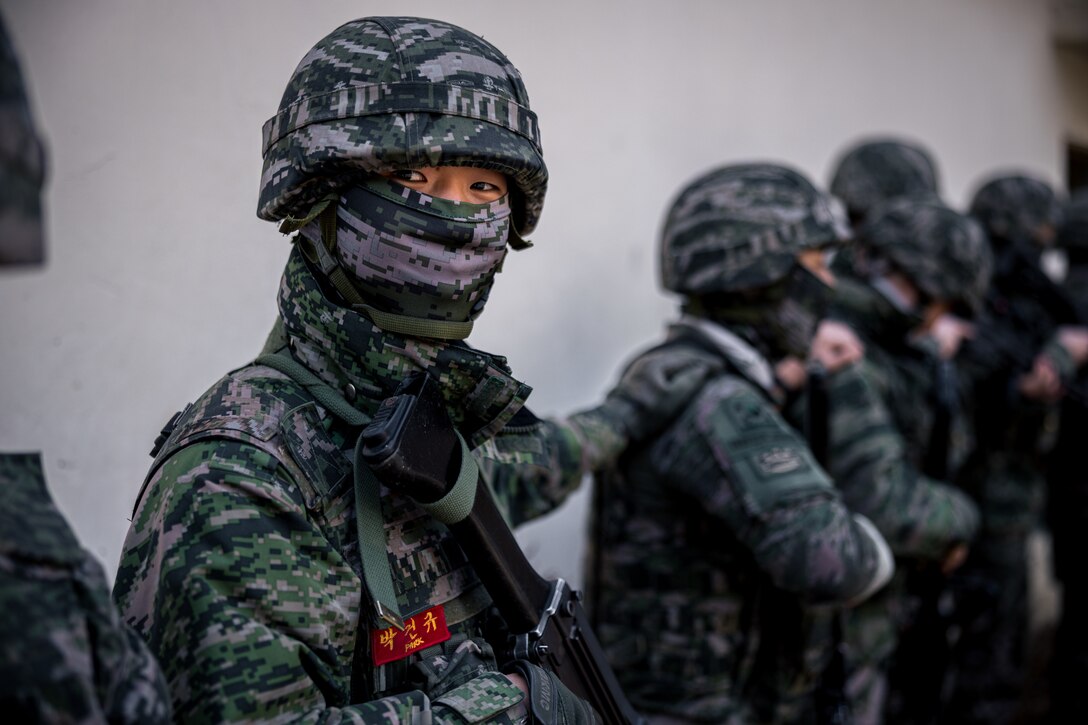 A Republic of Korea Marine with 23rd Battalion, 1st ROK Marine Division prepares to clear a room while executing military operations in urban terrain tactics during Warrior Shield 24 at ROK Marine Corps Base Pohang, South Korea, March 11, 2024. Warrior Shield 24 is an annual joint, combined exercise held on the Korean Peninsula that seeks to strengthen the combined defensive capabilities of ROK and U.S. forces. This routine, regularly scheduled, field training exercise provides the ROK and U.S. Marines the opportunity to rehearse combined operations, exchange knowledge, and demonstrate the strength and capabilities of the ROK-U.S. Alliance. (U.S. Marine Corps photo by Lance Cpl. Matthew Morales)