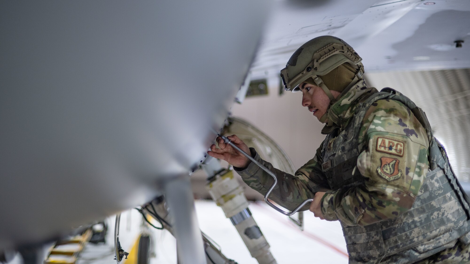 Staff Sgt. Juan Monroy conducts maintenance on an F-16 Fighting Falcon.